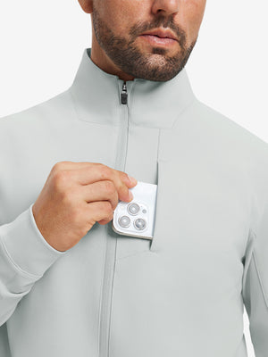 Close detail of hand in chest pocket of water-resistant zip up golf jacket in silver grey.