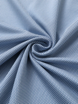 Close-up of light blue performance ananas jacquard polo fabric showing refined texture.