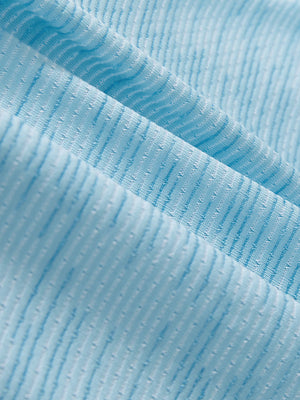 Close-up texture of misty blue featherweight midlayer quarter zip pullover fabric showing detailed lightweight material and weave.