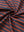 Close-up of rusty red navy yarn dyed stripe polo fabric showing distinct woven stripes and textured surface. 