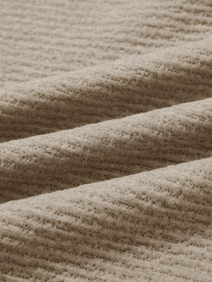 Close-up of fabric on texture solid hoodies pullover, showing texture and finish in light brown heather.