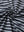 Close-up of navy grey yarn dyed stripe polo fabric showing distinct woven stripes and textured surface.