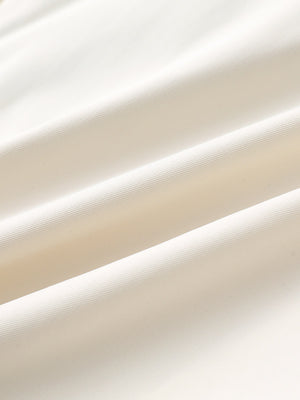 Close-up of beige water resistant golf shorts fabric texture.