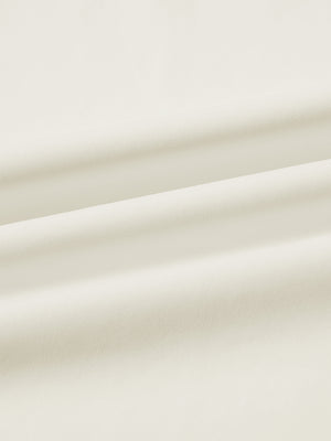 Fabric close-up of print collar quarter zip golf vest, smooth material with subtle texture in cream