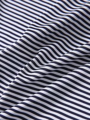 Close-up of navy stripe cooling stripe golf shirt fabric showing breathable texture and moisture-wicking stripes.