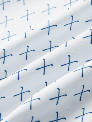 Close-up fabric detail of performance quick dry print golf polos, breathable texture with white nav clue pattern