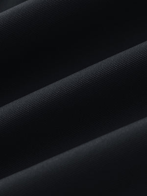 Fabric close-up of Women's 7/8 ankle golf track pants with soft texture in black