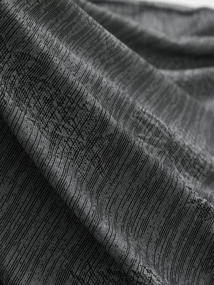 Close-up of grey pineapple breathable jacquard pattern 3-button golf polo fabric texture