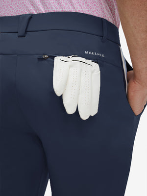 Detail view of back pocket on navy breathable casual slacks with 4 pockets