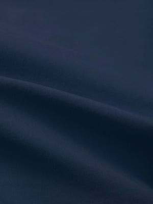 Close-up texture of dark blue flat front flex cotton blend golf shorts fabric showing detailed cotton blend material and weave.