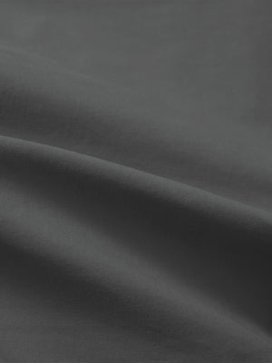 Close-up texture of dark grey flat front flex cotton blend golf shorts fabric showing detailed cotton blend material and weave.