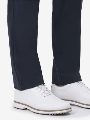Detail view of hem and lower leg on navy women's regular fit stretchy golf pants