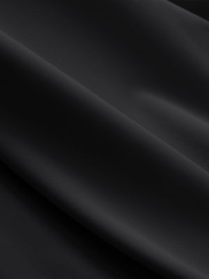 Close-up texture of black breathable casual slacks with 4 pockets fabric showing detailed breathable material and weave.