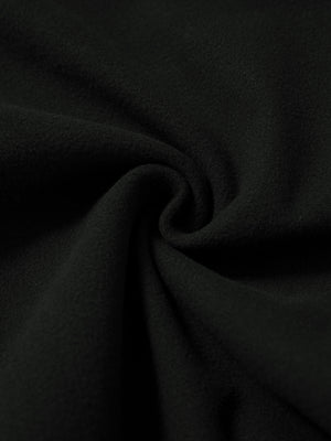 Fabric close-up of black water resistant comfy fleece golf joggers, soft fleece texture with water-resistant finish.