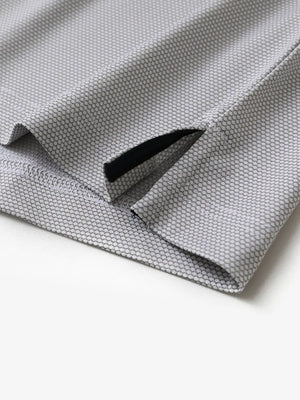 Close-up of side hem slit detail on GREY WHITE Performance Ananas Jacquard Polo
