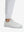 Detail view of hem on white flat front golf joggers pants with belt loops
