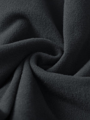 Fabric close-up of black boys stretch fleece lined casual golf pants, soft stretch fabric with warm fleece lining.