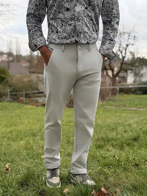 Front lower body shot of model wearing thermal water repellent fleece dress pants in light gray