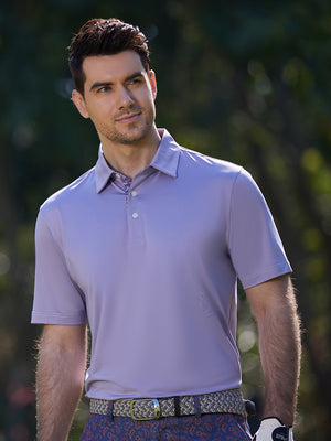Model in lavender everyday classic solid polo standing outdoors, waist-up shot.