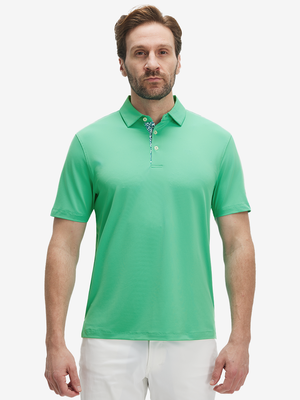 Front half-body view of a model wearing the irland green everyday classic solid polo, displaying the chest pocket detail