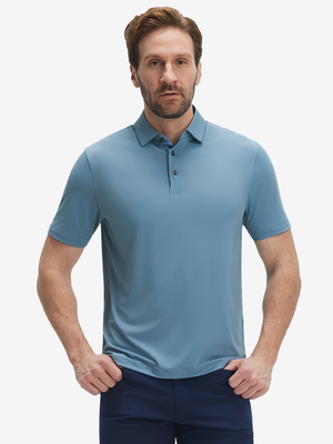Front half-body view of a model wearing the misty blue everyday classic solid polo, displaying the chest pocket detail