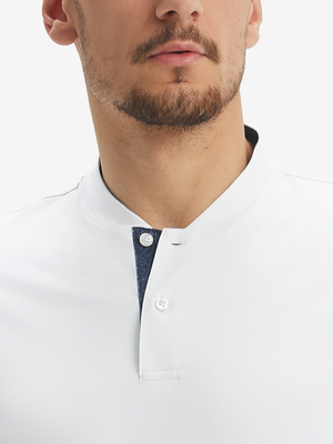 Close-up of model in white moisture-wicking short sleeve henley shirt, nose to chest view.