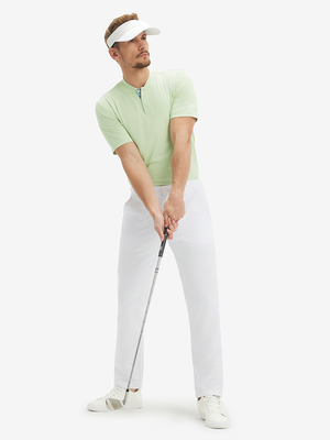 Full-body front: model in light green moisture-wicking short sleeve henley shirt addressing golf ball.