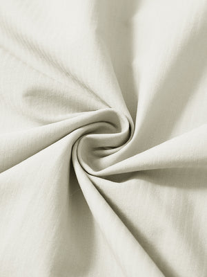 Close-up fabric detail of lightweight water-resistant outerwear jacket, smooth beige texture